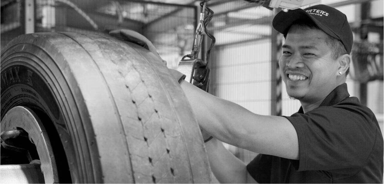 A Carter's technician working on a truck tyre